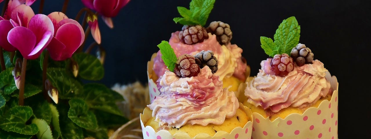 Three picture perfect muffins, showcased on a glass plate.