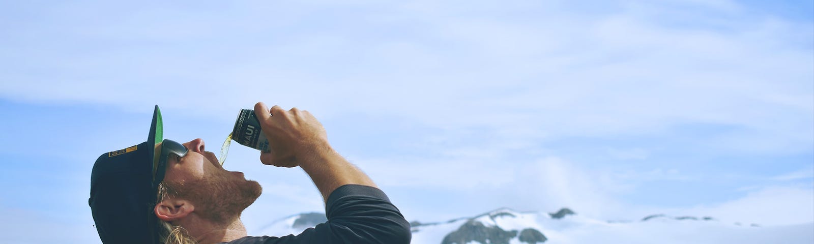 man pouring beer into his open mouth