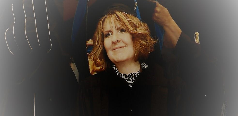 The author being hooded at their PhD ceremony during graduation