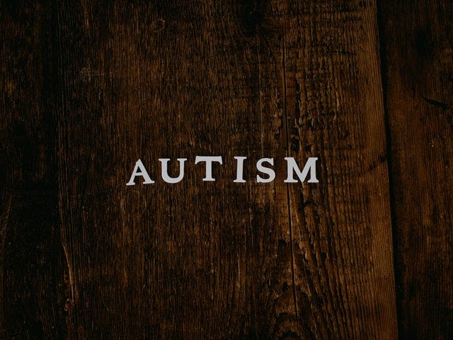 A oak background with the word autism