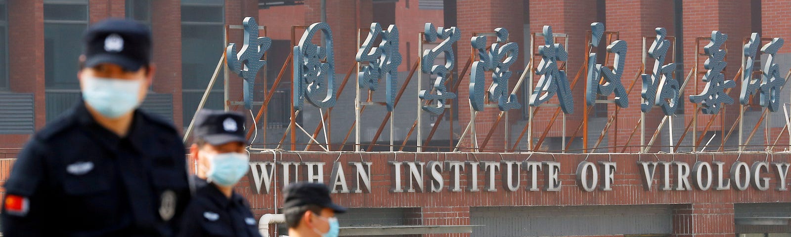 Security personnel at the Wuhan Institute of Virology during the visit by a World Health Organization team investigating the origins of COVID-19, in Wuhan, China, February 3, 2021. Photo by Thomas Peter/Reuters