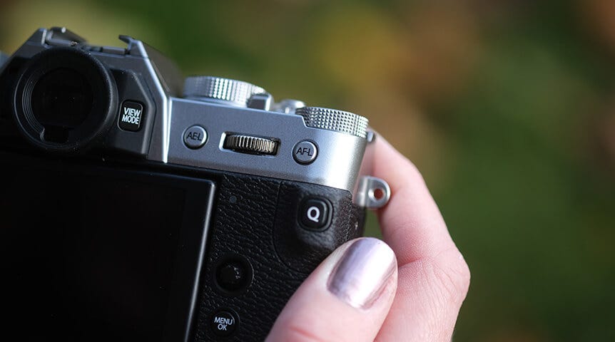 Close-up of woman’s hand holding FUJIFILM camera