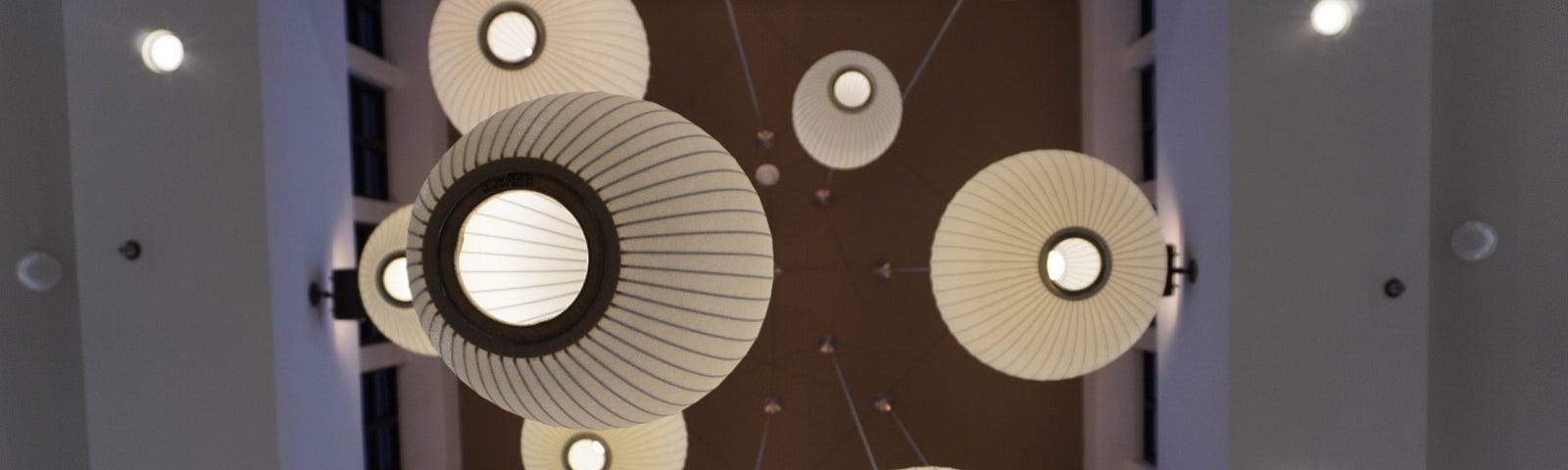 A view of a bunch of overhead lights from below.