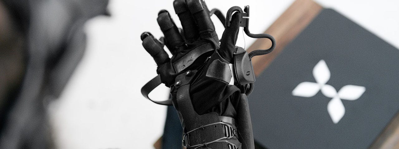 Woman wearing HaptX brand haptic gloves for VR and telerobotics.