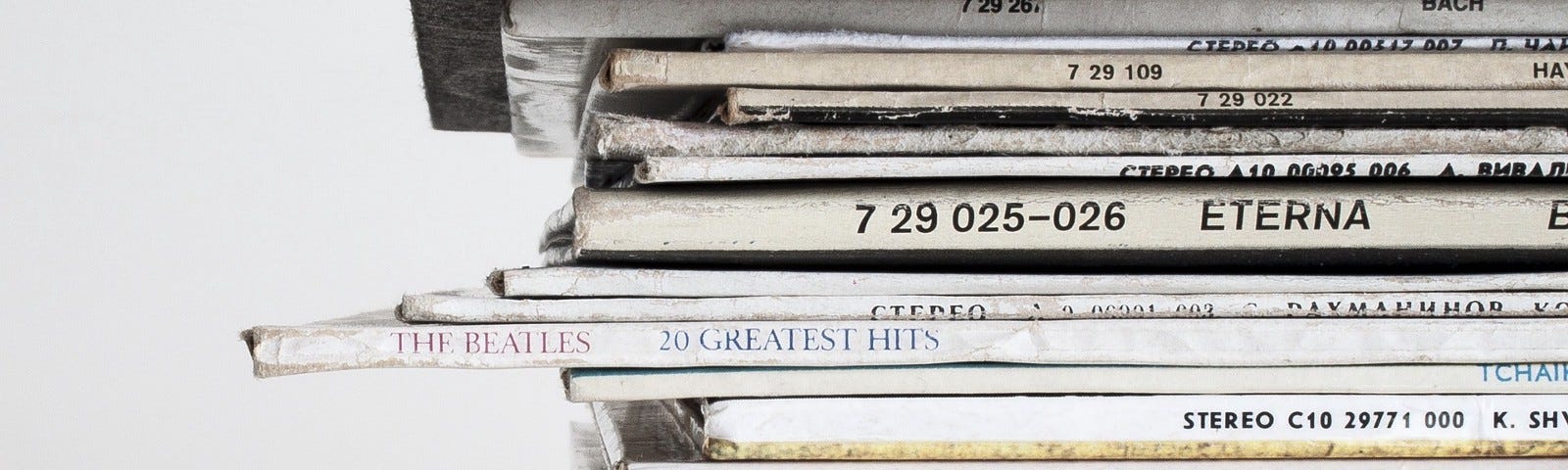 Photograph of a stack of vinyl records, showing titles