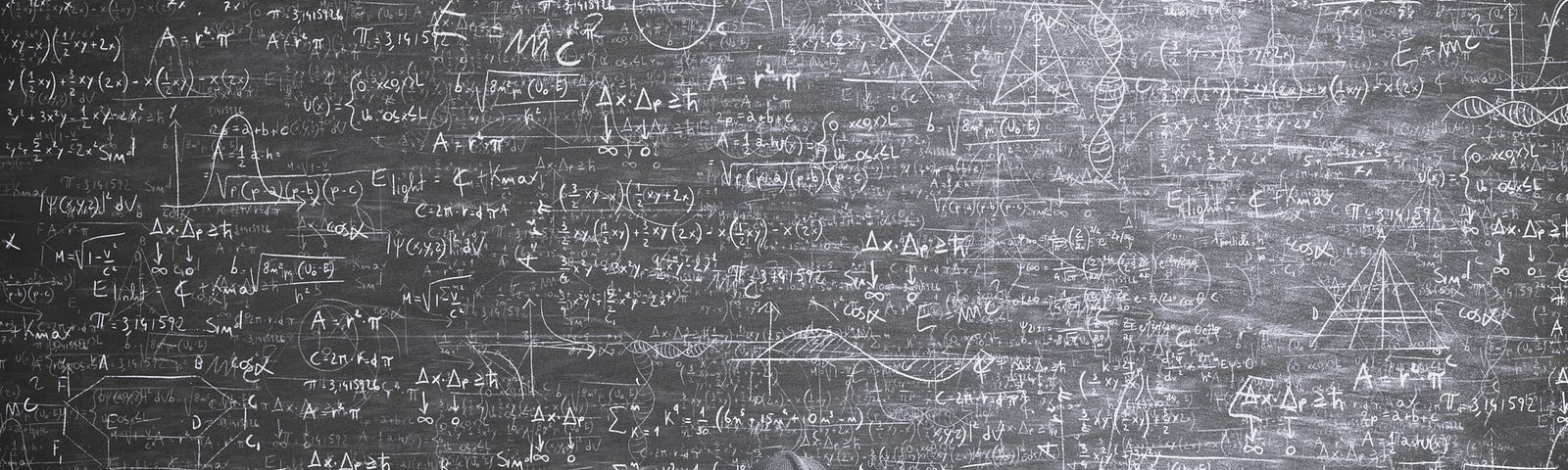 Man standing in front of a huge chalkboard covered with mathematical equations.