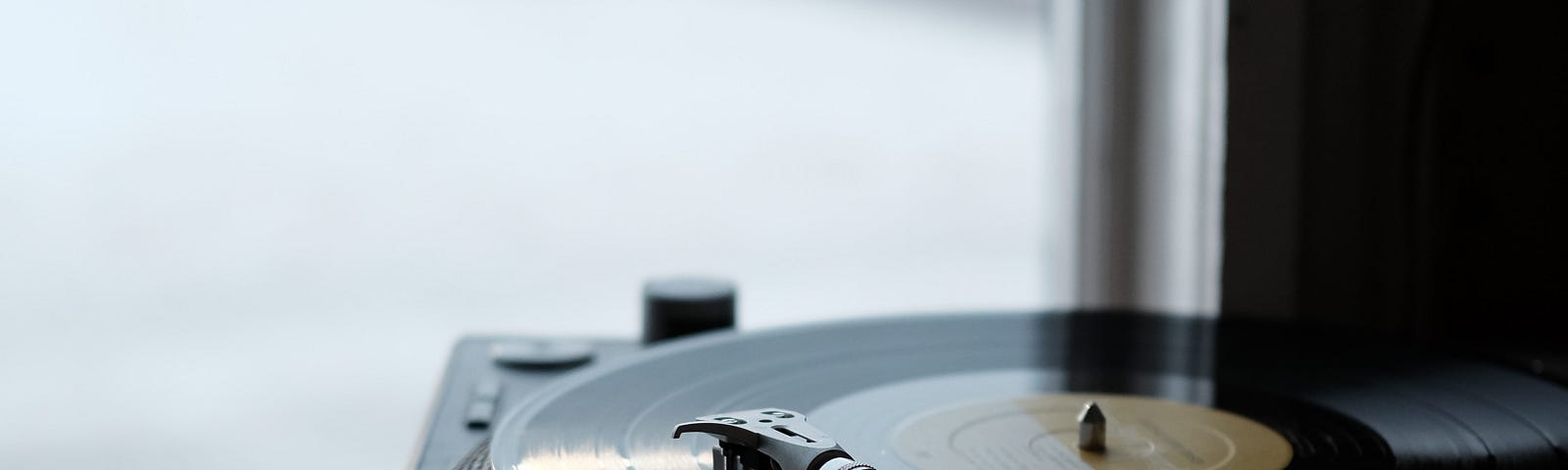 Photo of turntable and records by Wesley Gibbs on Unsplash.