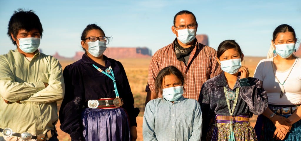 Native family wearing surgical masks