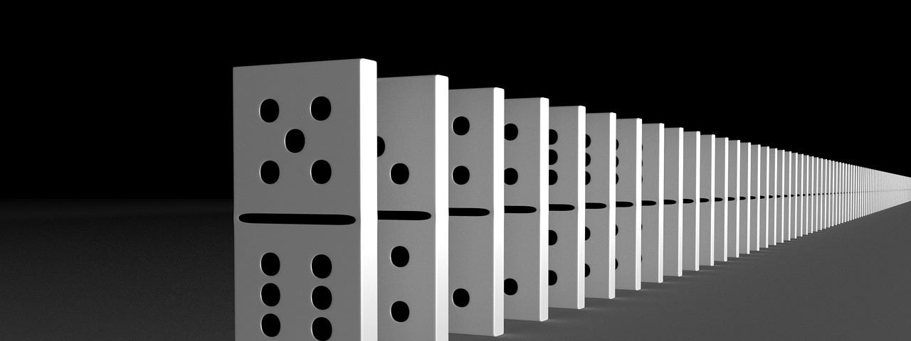 a chain of white dominoes on a black gradient background