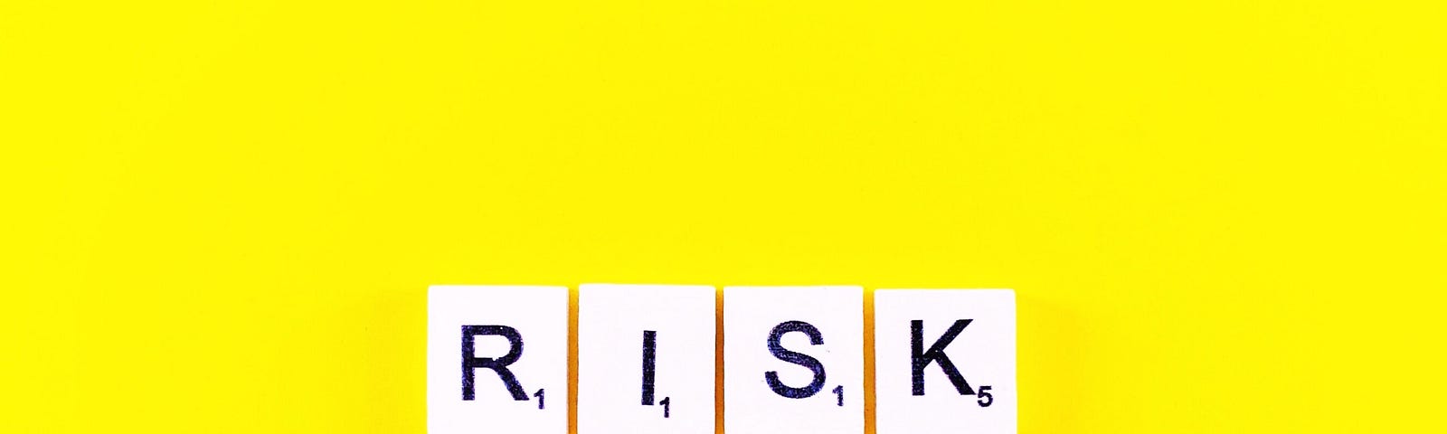 Risk spelled out in scrabble letters