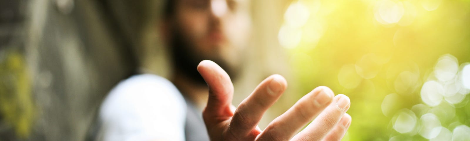 Giving a helping hand, asking or offering help close-up shot of a Caucasian man in a business suit.