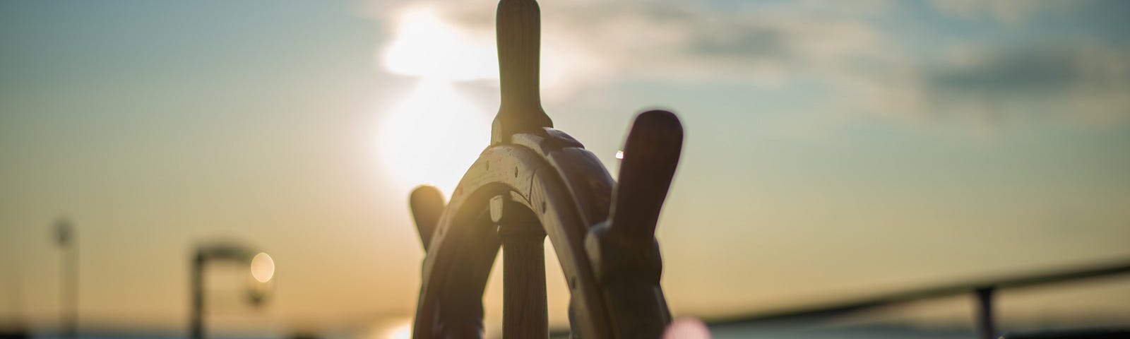 Sun set image of a boats steering wheel