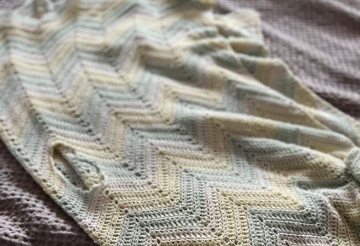Handmade baby blanket with a large hold in it. Photo by Ellie Jacobson.