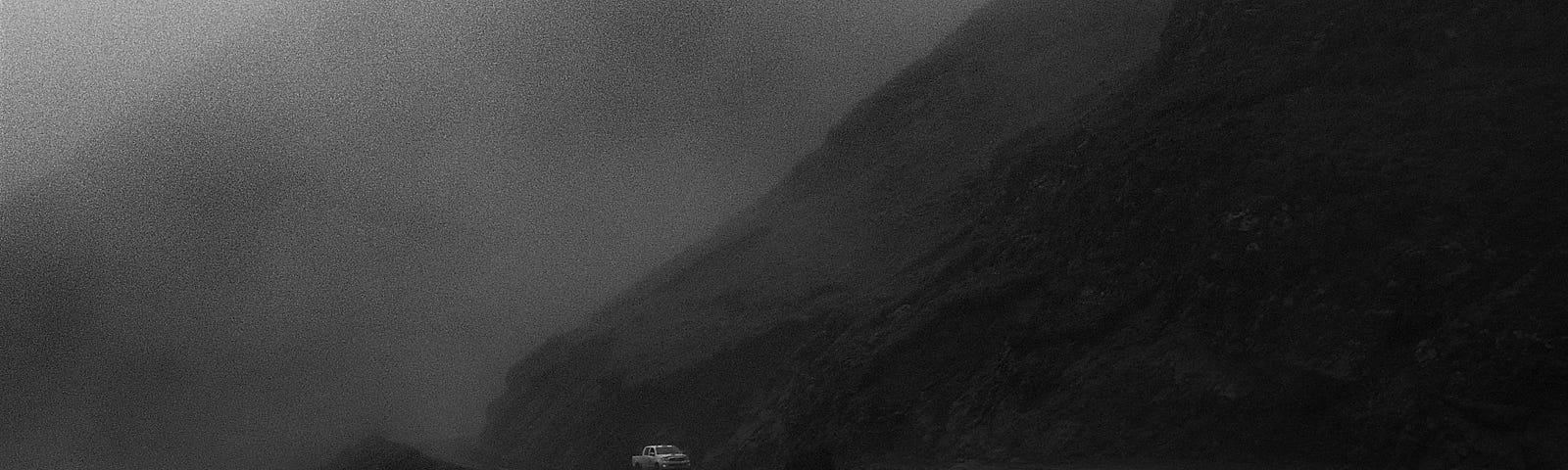 A car on a dark mountain road.