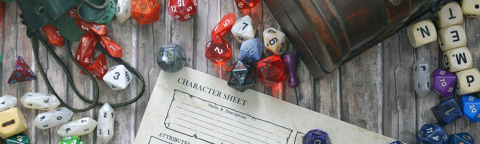 a variety of dice spread out over a partially-covered character sheet