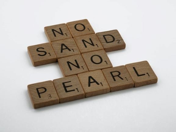 No sand. No pearl. — stacked as words underneath each other-made of Scrabble tiles