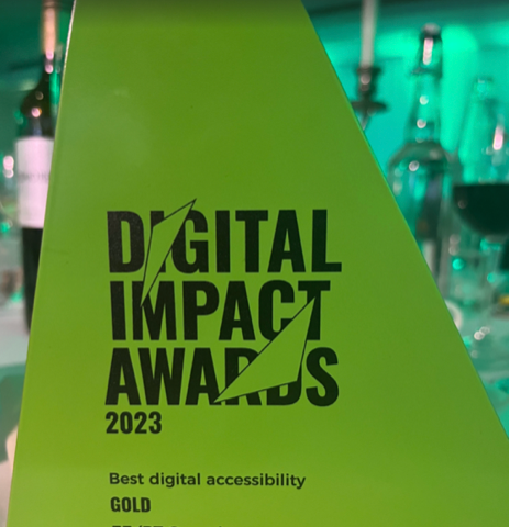 Digital Impact Awards 2023 — Gold Best Digital Accessibility: The trophy is green and in a triangular shape.