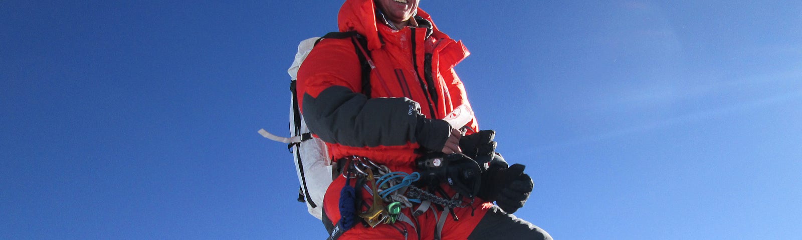 Walter Hailes stands atop Mount Everest.