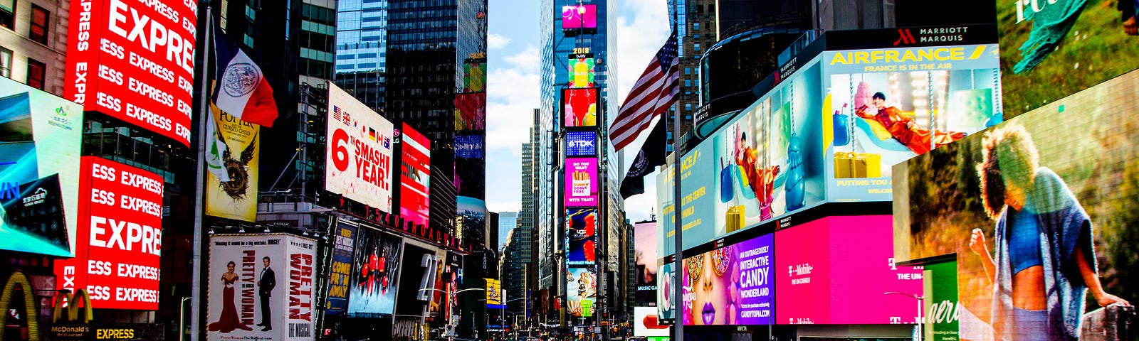 Photograph of New York City’s Times Square at night with many ads in background