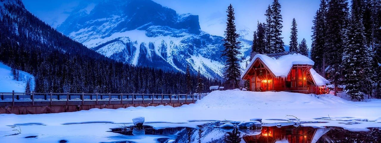 Snow covered log cabin