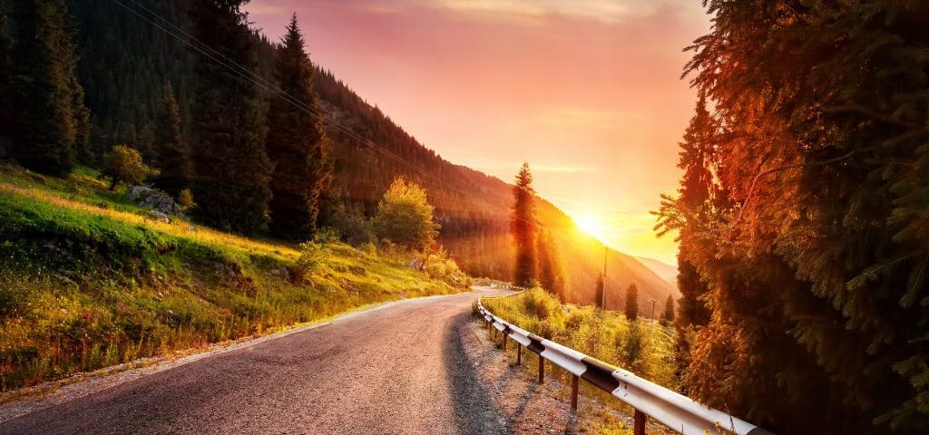 A scenic road going straight in sunrise colours