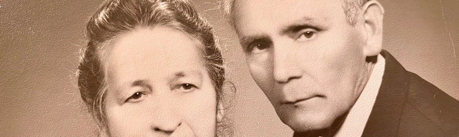 A sepia portrait of a man and woman in their late years.