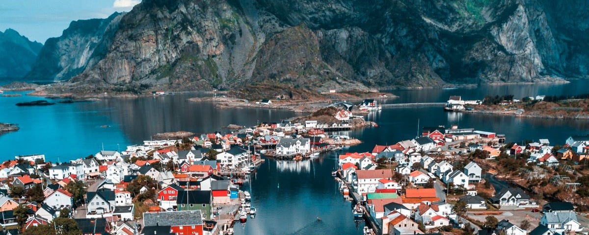 A town situated on the water between mountains.