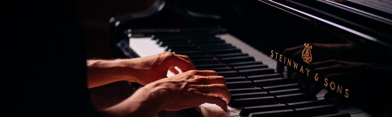 hands poised above piano keys