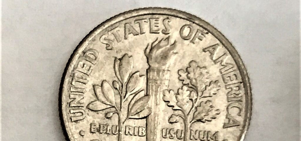 The reverse face of a US dime. It bears the phrases “United States of America,” “One dime,” and “E pluribus unum.” It also shows two branches and a torch, arranged vertically. The stems of the branches, and the handle of the torch, pass through the phrase “E pluribus unum,” making it appear as “Eplu rib usu num.”