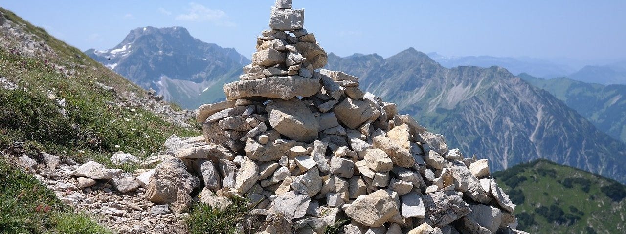 Stone cairn in mountains.