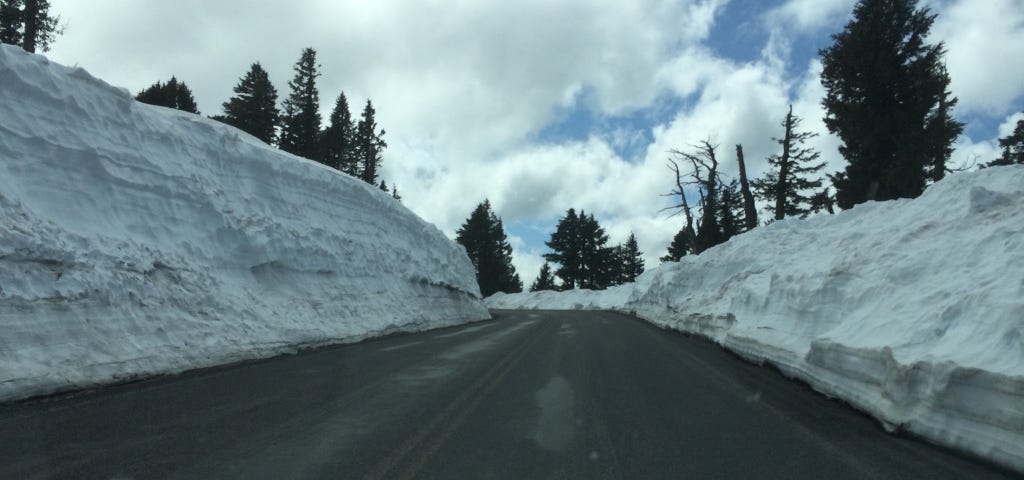 Road to Crater Lake Visitor Center in early spring with 10 feet of plowed snow.