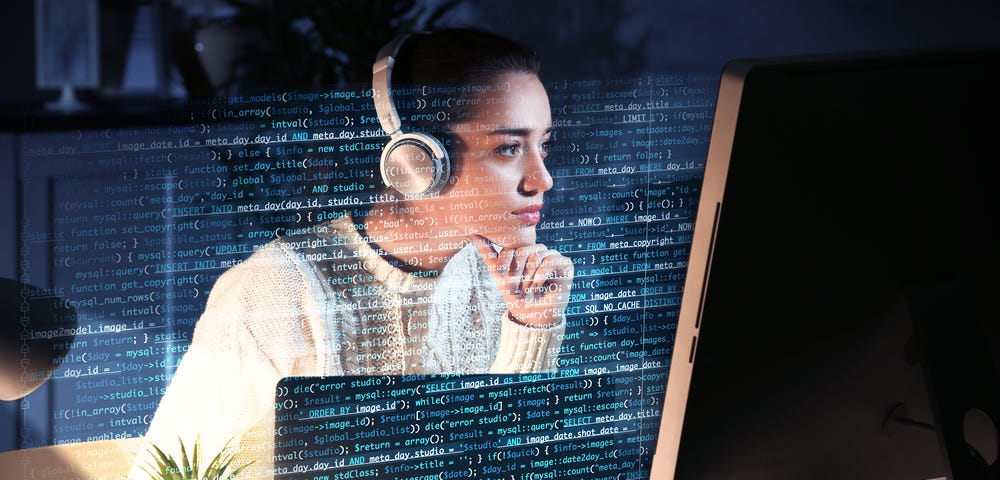 A women writing code on her computer