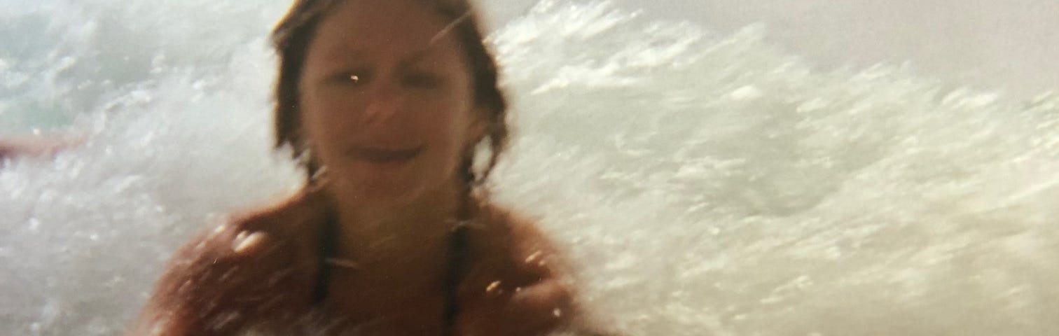 A young girl playing in the waves