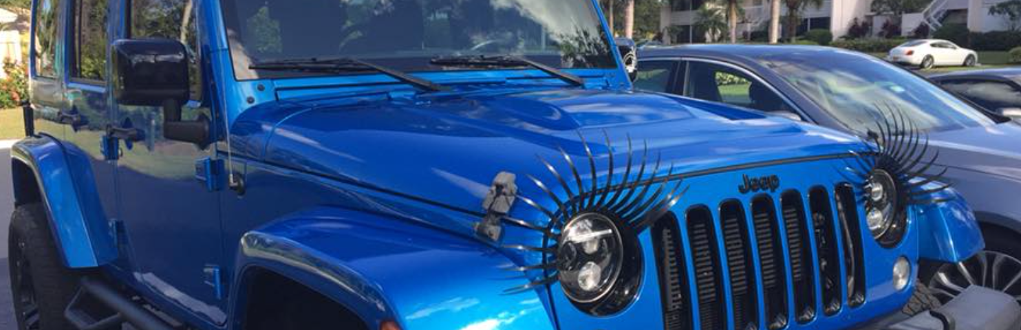 Nautical blue Jeep Sahara Wrangler with black headlight eyelashes