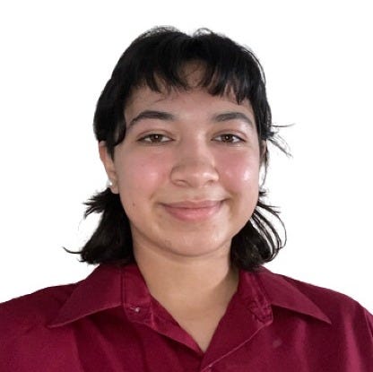 A picture of Diana, a young Hispanic woman, from the chest up. She is seen wearing an unbuttoned blouse and relaxed hairstyle that frames her face. A close-lipped smile is also presented.