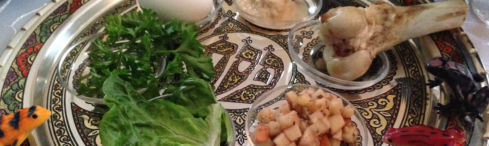 Photo of a traditional Passover Seder plate, lined with plastic frogs.