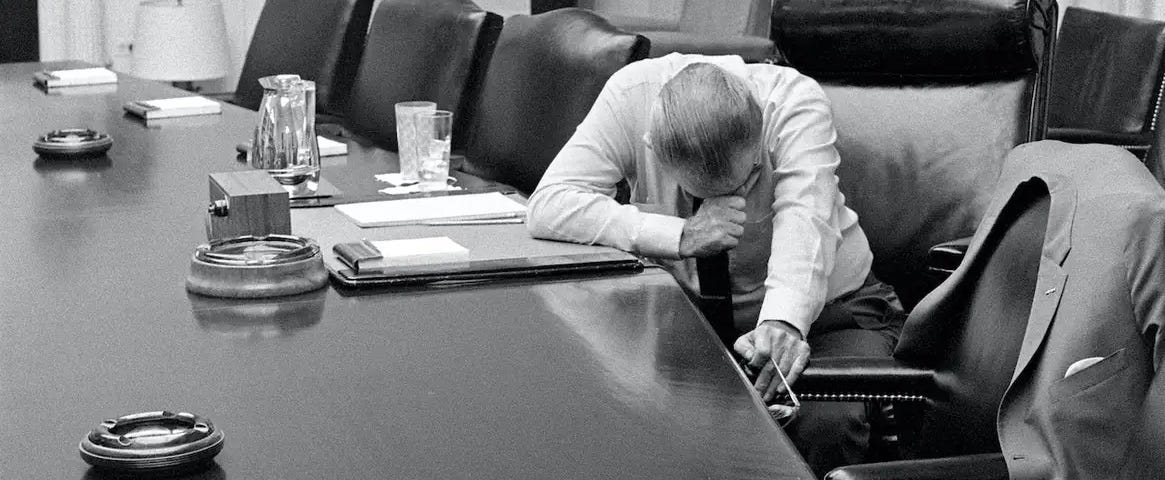 Photograph of LBJ. Apparently his head is down not because he’s mourning, but because the tape they’re trying to listen to is difficult to hear. Still manages to make the point I’m trying at about teaching.