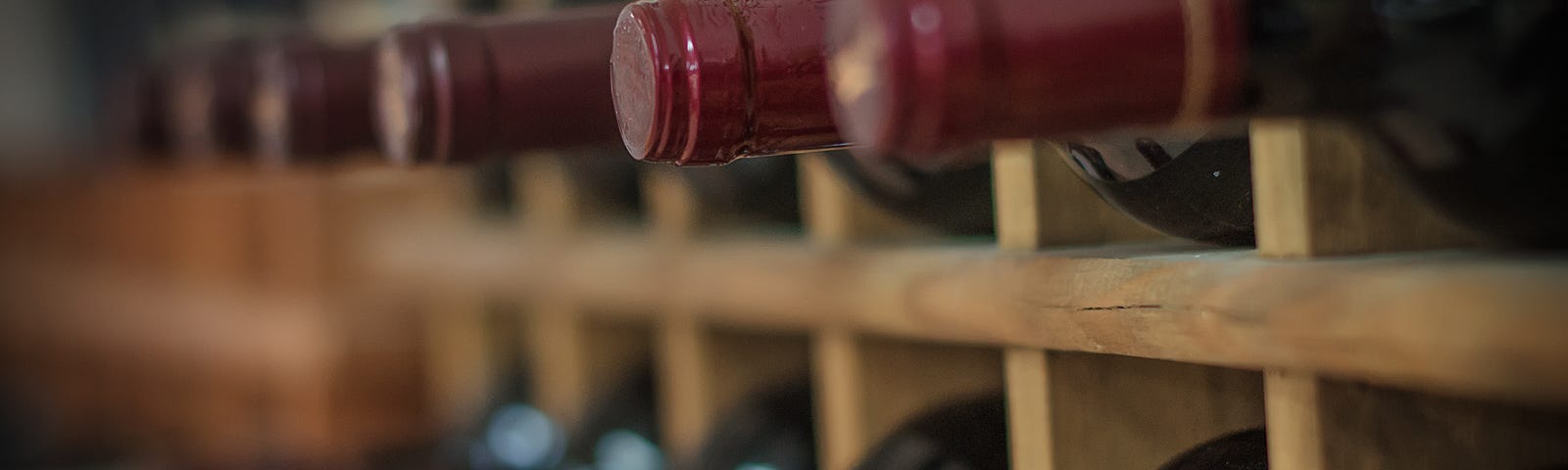Red wine bottles on wooden racks