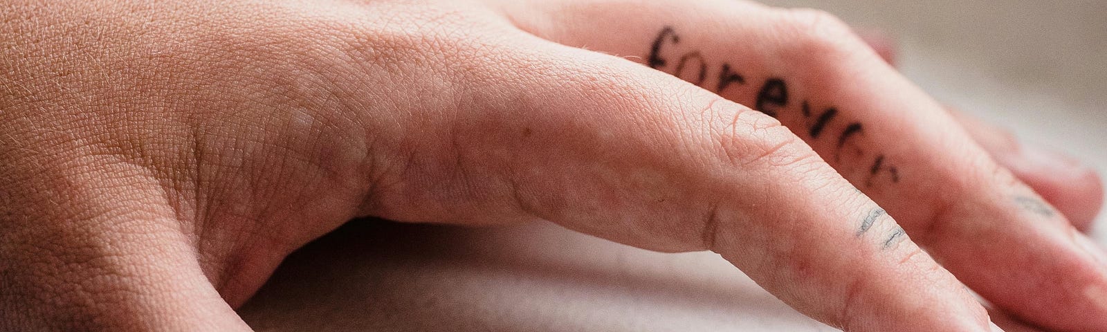 Close-up of a Hand with a Finger Tattoo. Photo by Mizuno K from www.pexels.com.