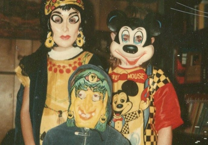 This photo shows three children with Halloween masks in the 1970s.