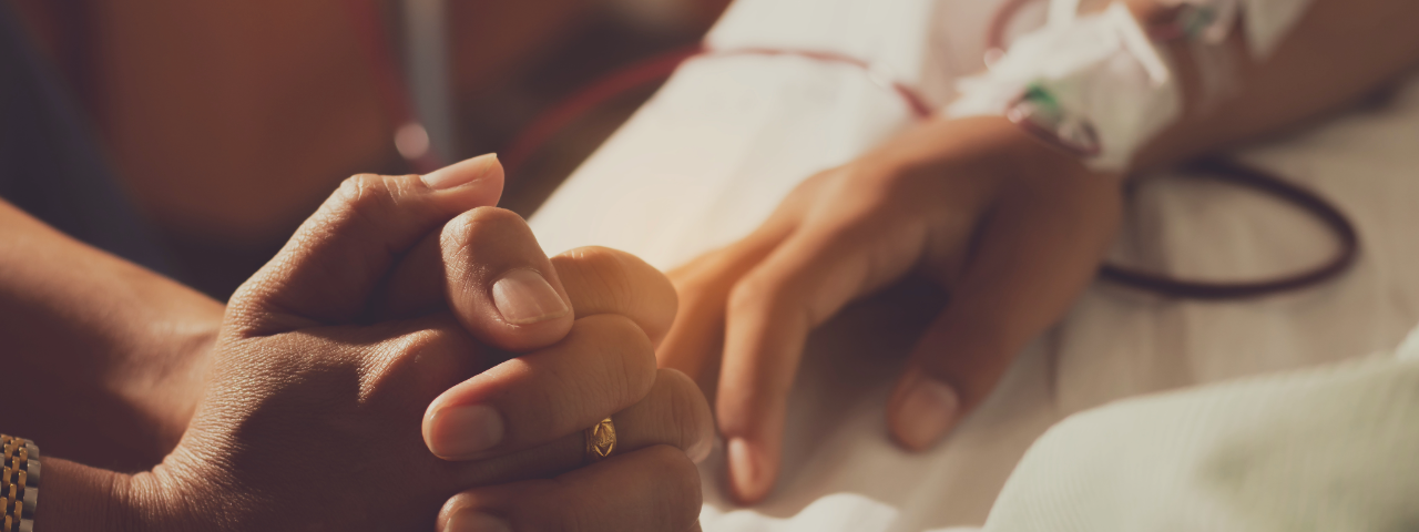 The hands of two people at the hospital