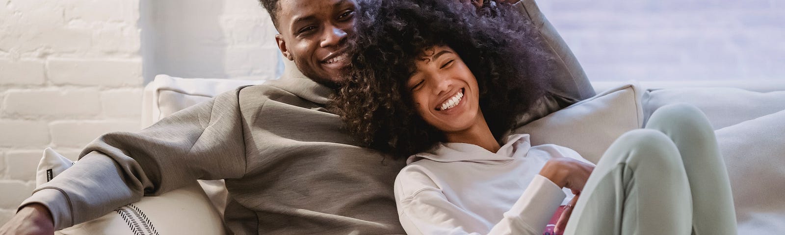 Couple sitting on couch, smiling. Limits: The Key to a Thriving Life