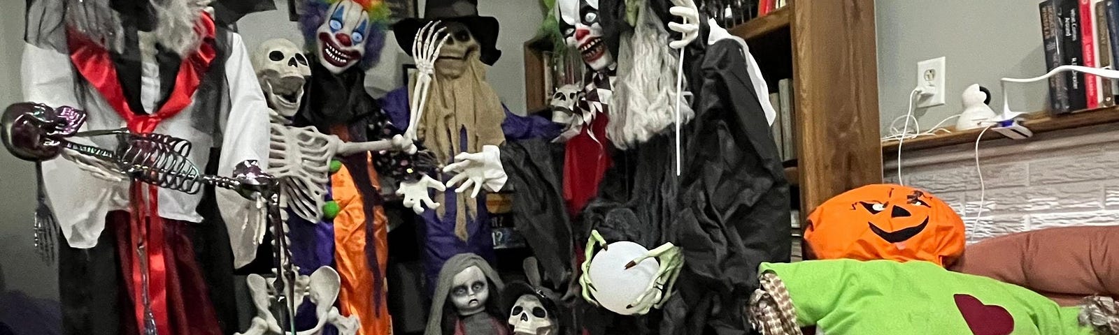 Several Halloween skeleton figurines posed together for a mock family photo.