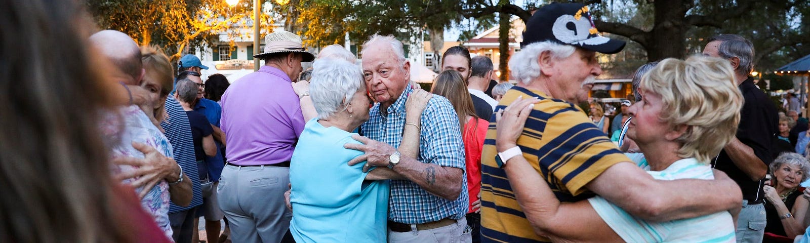 Betty Pochinski, 77 and Ed Wilson, 83 dance as band plays in Lake Sumter Landing Market Square in The Villages, Florida on March 11, 2020.