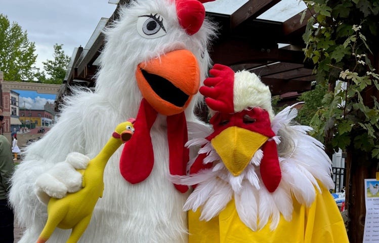 Two people in full body chicken costumes
