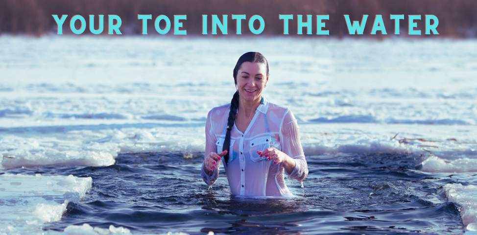 A woman standing in the ocean surrounded by ice.