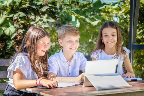 Three children sharing a laptop
