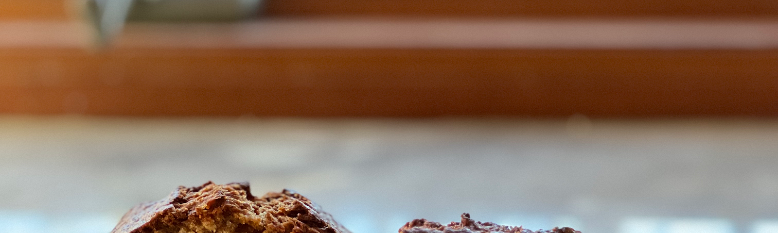 Apple carrot bread on a wooden board in front of a window