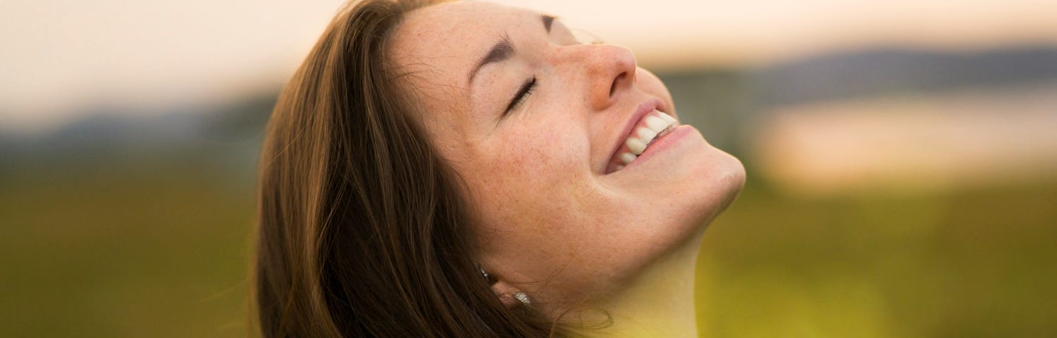 A woman smiling to illustrate the core message of this near-death experience.