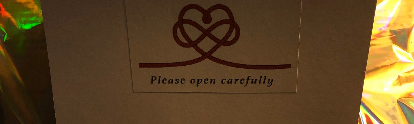 The front of a homemade greeting card with the words “Please open carefully.”